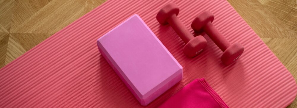 pink dumbbell on pink textile